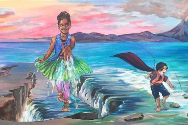 Mural of two young costumed figures playing in the ocean with a volcano in the background
